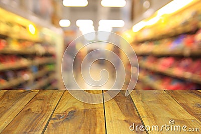 Blurred image wood table and abstract generic supermarket people Stock Photo