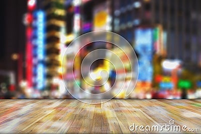 Blurred images of bokeh light and renown night life background montage photo with wooden top table for product display Stock Photo