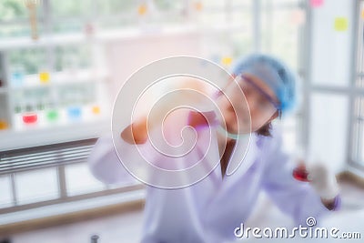 Blurred male scientist holding substance he has just successfully experimented. Stock Photo