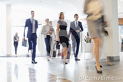 Blurred motion of business people walking at convention center Stock Photo