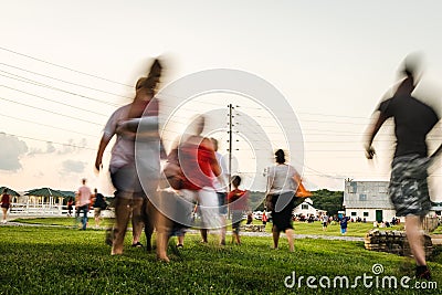 Blurred Motion of People Walking To An Outdoor Concert Editorial Stock Photo