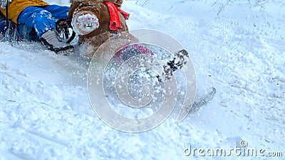 Children sliding on snowy mountain Stock Photo