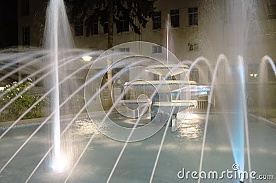 Blurred movement of water in the fountain, illuminated with lights Stock Photo