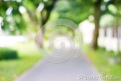 Blurred park with side walk on green nature background Stock Photo