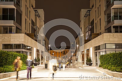 Blurred pedestrian in the city at night, zoom effect, motion blu Stock Photo