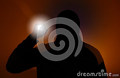 Blurred photo. Burglar in dark clothes holding the flashlight. Dangerous robber in mask with a torch. Criminal man Stock Photo