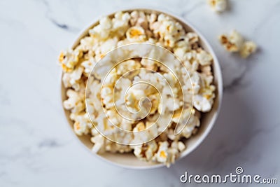 Blurred popcorn bowl background, defocus concept, top view. Snack for movie Stock Photo