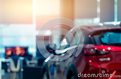 Blurred rear view of red car. Luxury car parked in modern showroom. Car dealership office. Automobile retail shop. Electric and Stock Photo