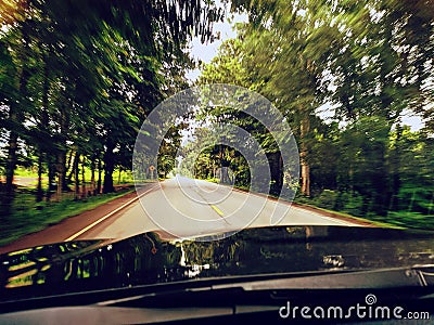 Blurred of road landscape look through windshield Stock Photo