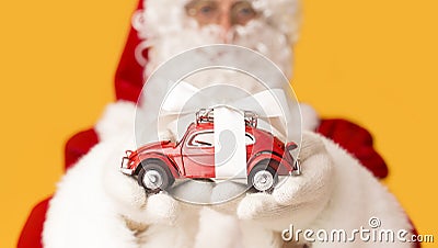 Blurred Santa Claus suggesting toy car with present bow Stock Photo