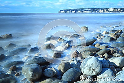 Blurred sea waves near town of Seaton Stock Photo