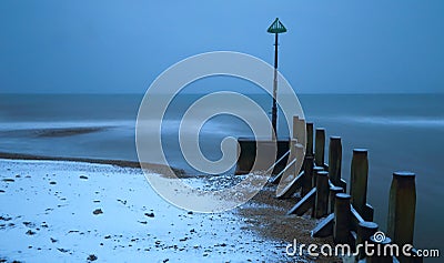 Blurred sea waves on a snowy beach Stock Photo