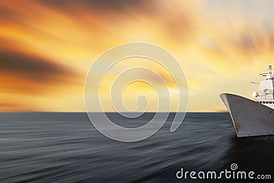 Blurred seascape with a warship at the edge of the image. Abstract motion blurred sea with sunset sky and army battleship Stock Photo