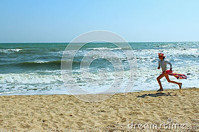 Blurred Shot Of A Young Girl Running On The Beach. People, Childhood, Travel Concept. Stock Photo