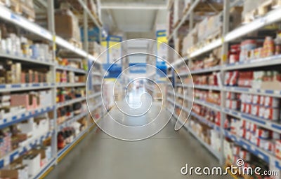 Blurred supermarket aisle with colorful shelves of merchandise. Perspective view Stock Photo