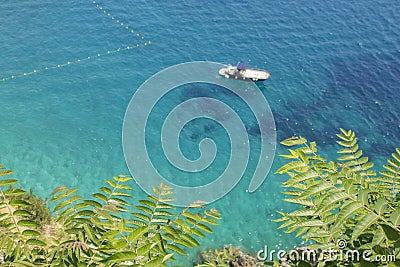 Blurred tropical waters with floating boat Stock Photo