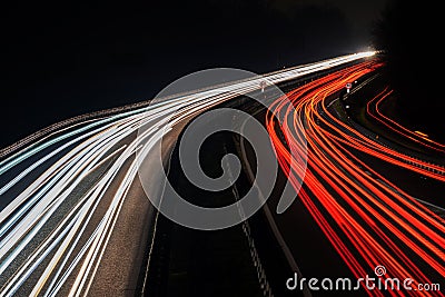 Blurred truck lights. Abstract image of night traffic lights on the road. Car light trails at night in curve asphalt Stock Photo