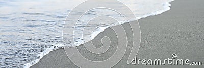 Blurred wave of the sea on the evening sand beach. banner. Editorial Stock Photo