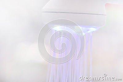 Blurred white shower head LED light for background, modern shower head LED lighting in blur picture for background Stock Photo