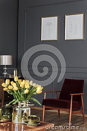 Blurred yellow tulips on wooden table in retro living room inter Stock Photo