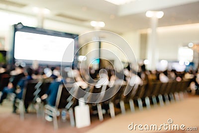 Blurry of auditorium for shareholders` meeting or seminar event with projector and white screen Stock Photo