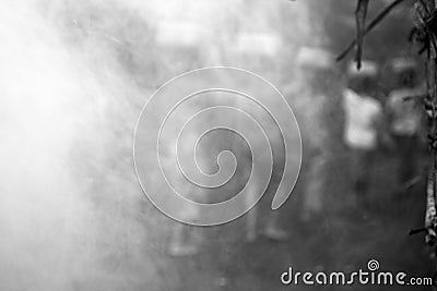 Blurry background of Balinese women with basket on their head walking on a misty morning mist. People abstract backgrounds. Stock Photo