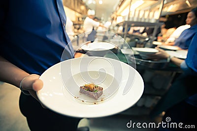 Blurry background vintage color style of food on hand waiter Stock Photo