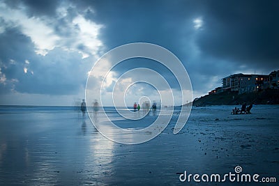 Blurry beach walkers on Blue Mountain Beach Stock Photo