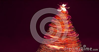 Blurry creative lighted christmas tree banner in red orange palette on a dark background. Xmas and New Year greeting card concept Stock Photo