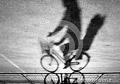 Blurry cyclist silhouette and shadow Stock Photo