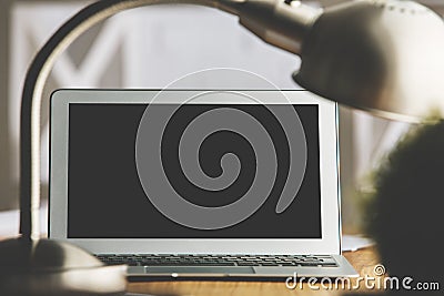 Blurry desk with laptop and lamp Stock Photo