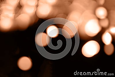 Blurry garland lights on a dark background. Festive Christmas and New Year background. Soft focus. Image toned in color Stock Photo