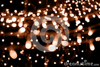 Blurry garland lights on a dark background. Festive Christmas and New Year background. Soft focus. Image toned in color Stock Photo