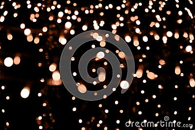 Blurry garland lights on a dark background. Festive Christmas and New Year background. Soft focus. Image toned in color Stock Photo