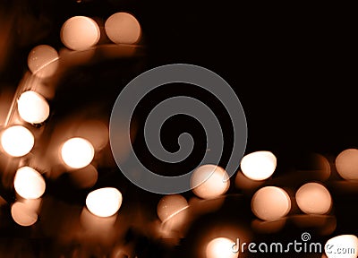 Blurry garland lights on a dark background. Festive Christmas and New Year background. Soft focus. Image toned in color Stock Photo