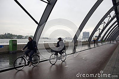 Blurry motion image of women riding a bicycles Editorial Stock Photo