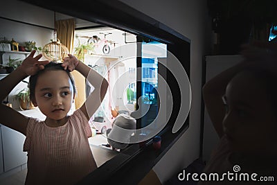 Blurry photo of a cute little girl mirror reflections in the living room Stock Photo
