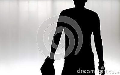 Blurry silhouette of one young man walking in the black and white night Stock Photo