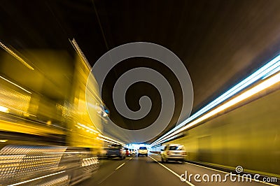 Blurry speeding car in a tunnel with light trails Stock Photo