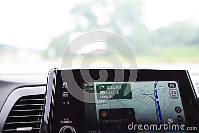 Blurry street view and Welcome to Oklahoma text message on screen of real-time GPS navigation map application on display Stock Photo