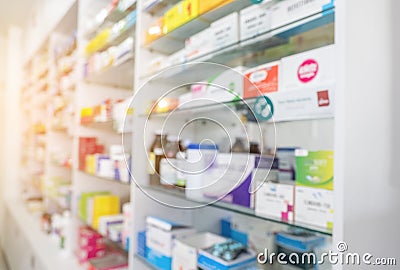 Blurry view of drug store and pharmacist. Blurred clean pharmacy with medicine on shelves. Defocus white drugstore Stock Photo