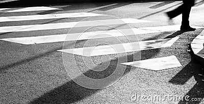 Blurry zebra crossing with person silhouette and shadow Stock Photo