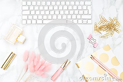 Blush and gold feminine desktop with makeup and keyboard. Copy sp Stock Photo