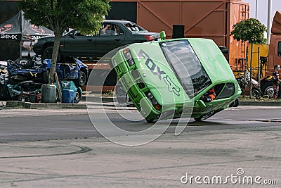BMW car rides sideways on two wheels, at an auto show in the city of Halle Saale, Germany, 04.082019 Editorial Stock Photo