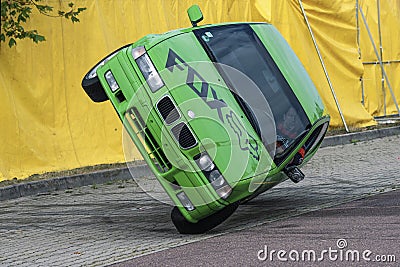 BMW car rides sideways on two wheels, at an auto show in the city of Halle Saale, Germany, 04.082019 Editorial Stock Photo