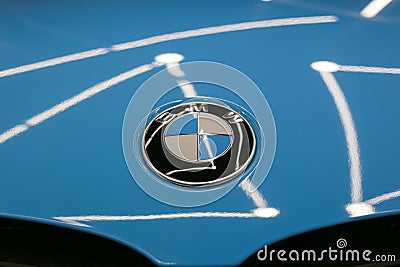 The BMW logo on the hood of the car is sky blue. Close-up, top view. Editorial Stock Photo