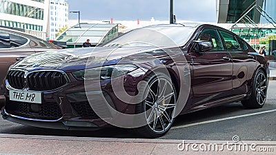 BMW M8 Competition Gran Coupe in Ametrin metallic color parked on the city street. Front side view of 4-door fastback sedan Editorial Stock Photo