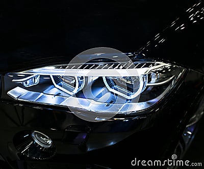 BMW X6M 2017. Headlight of a modern sport car. Front view of luxury sport car. Car exterior details. Editorial Stock Photo