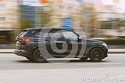 BMW X5 2018 model on city streets in action. Black SUV car in motion Editorial Stock Photo