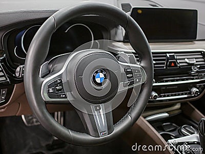 BMW X5 steering wheel and dashboard. Beige leather car interior. Editorial Stock Photo